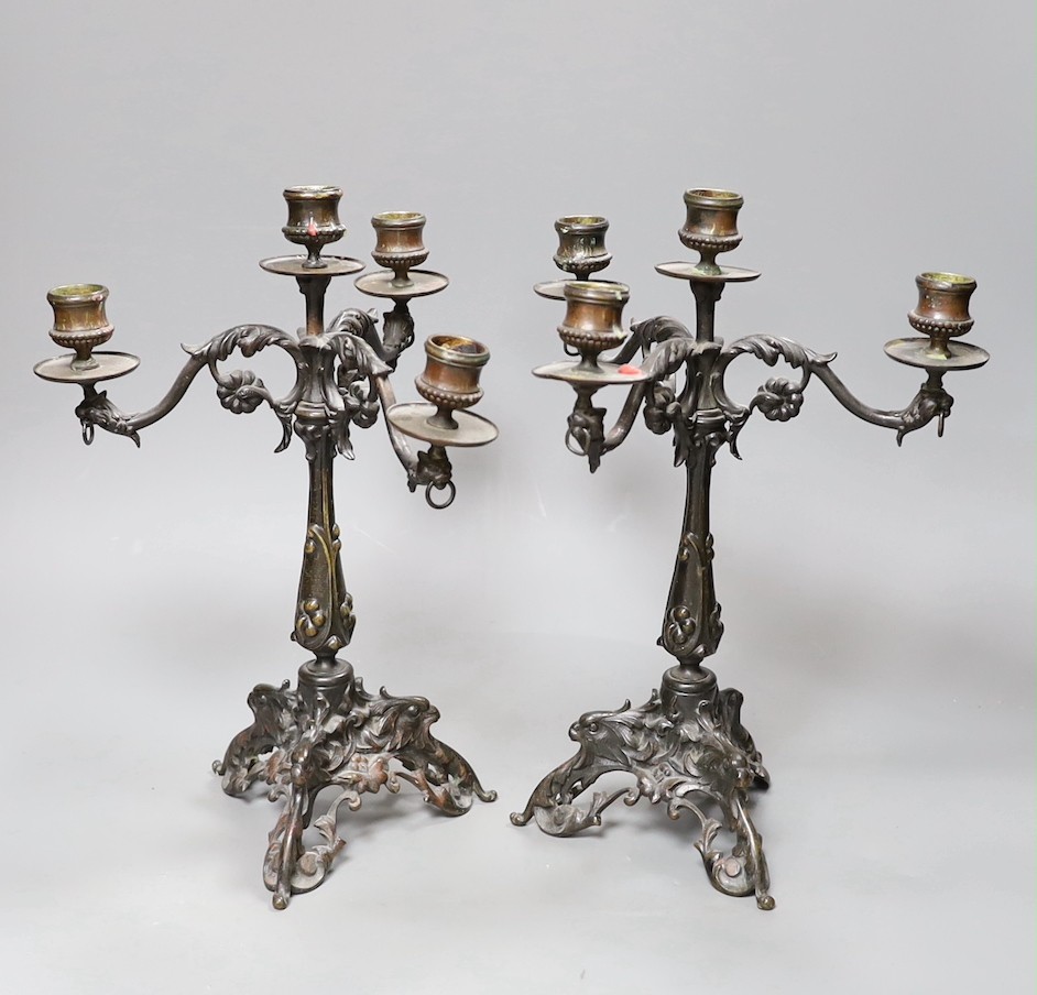 A pair of Victorian style bronze three branch candelabra, 32cm